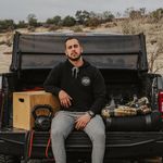 Owner of Gym Truck Chico Poses  On The Tailgate of his truck with his workout equipment